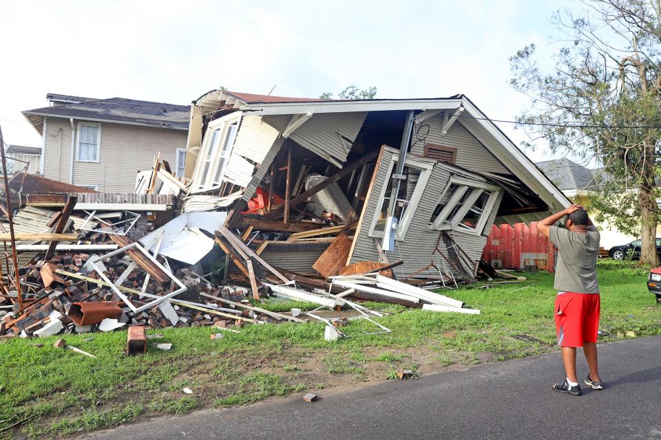 Monday, Aug. 20, 2021 - Dartanian Stovall looks at the house that collapsed with him inside during the height of Hurricane Ida in New Orleans. Stovall was inside the house he was renovating on Lasalle Street in the Uptown neighborhood when he said the chimney collapsed the rest of the house followed. He managed to crawl to safety and despite the loss of the home said, "At least I'm alive."