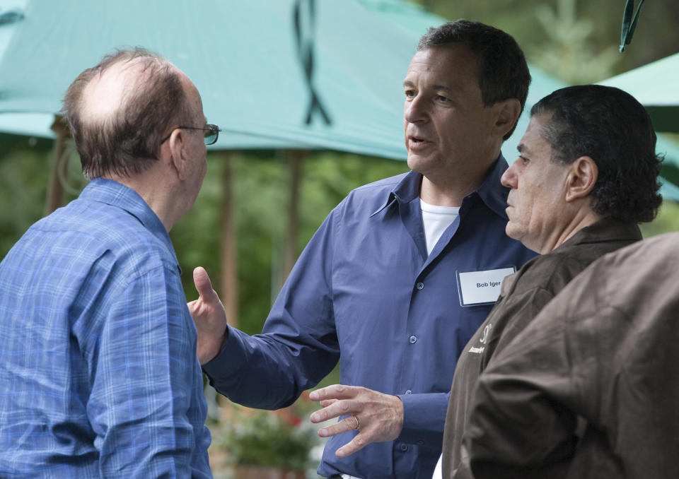 News Corporation Chairman and CEO Rupert Murdoch, left, chats with Disney's Robert Iger, center, and Haim Saban, at the annual Allen & Co.'s media summit in Sun Valley, Idaho, Wednesday, July 8, 2009. (AP Photo/Nati Harnik)