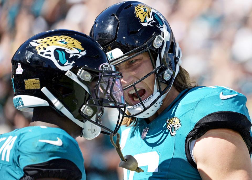 Jacksonville Jaguars running back Trevor Etienne (1) celebrates with quarterback Trevor Lawrence (16) after a touchdown run against the Indianapolis Colts at EverBank Stadium.