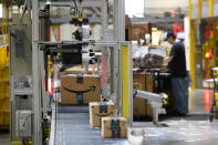 FILE- In this Aug. 3, 2017, file photo, packages pass through a scanner at an Amazon fulfillment center in Baltimore. Amazon will spend more than $700 million to provide additional training to about one-third of its U.S. workforce. (Photo/Patrick Semansky, File)