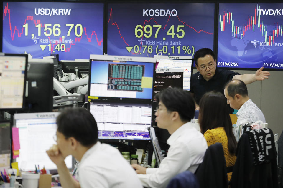 A currency trader gestures at the foreign exchange dealing room of the KEB Hana Bank headquarters in Seoul, South Korea, Friday, June 28, 2019. Asian stocks sank Friday as investors waited for a meeting between Presidents Donald Trump and Xi Jinping that they hope will produce a truce in spiraling U.S.-China trade tensions.(AP Photo/Ahn Young-joon)