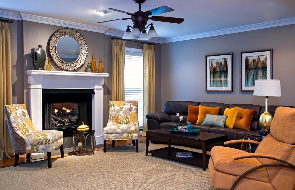 Pops of color were brought into this space with bright pillows, fabrics, and window treatments  in this redesigned living room in Louisville.