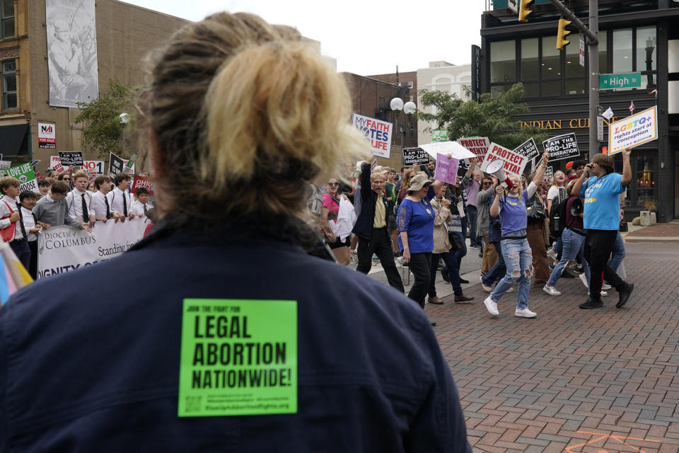 Marchers shout to a counter-protester calling for legal abortion nationwide as they move down High Street during the Ohio March for Life after a rally at the Ohio State House in Columbus, Ohio, Friday, Oct. 6, 2023. (AP Photo/Carolyn Kaster)
