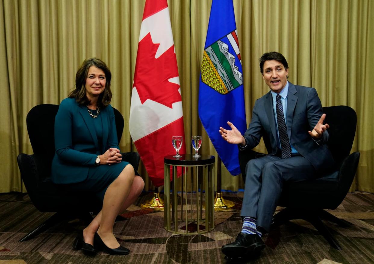 Prime Minister Justin Trudeau and Alberta Premier Danielle Smith were all (well, mostly) smiles for the cameras before their private one-on-one meeting Wednesday in Calgary. (Todd Korol/The Canadian Press - image credit)