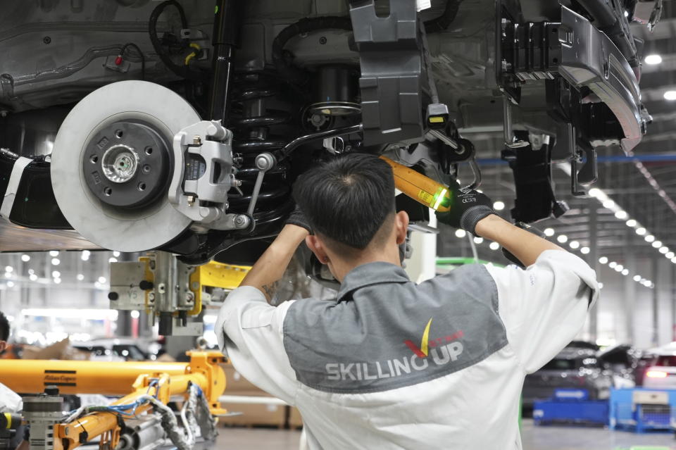 A worker assembles a car at a Vinfast factory in Hai Phong, Vietnam, on Sept. 29, 2023. Vietnamese automaker Vinfast has plunged right into the crowded and hypercompetitive U.S. auto market, gambling that if it can sell its electric vehicles to finicky Americans, it can succeed anywhere. So far, that gamble has yet to pay off. (AP Photo/Hau Dinh)