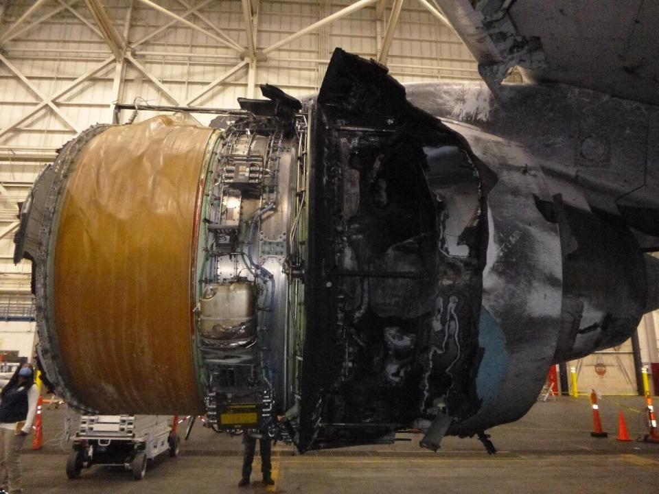 This photo provided by The National Transportation Safety Board shows the damaged engine of United Airlines Flight 328. Federal safety officials are updating their investigation into the engine failure on the United Airlines plane that sent parts of the engine housing raining down on Denver-area neighborhoods last month. The National Transportation Safety Board said Friday, March 5, 2021 that a microscopic exam confirmed that a fan blade that snapped off had telltale signs of fatigue — tiny cracks caused by wear and tear. (The National Transportation Safety Board via AP)
