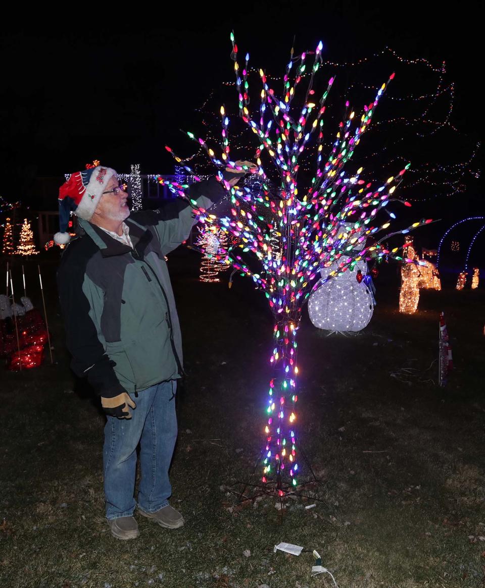 Dan Rambacher in front of his home Friday in Sagamore Hills. The Rambachers raised over $37,000 for St. Jude's Hospital in donations from admirers of their Christmas light display this season.