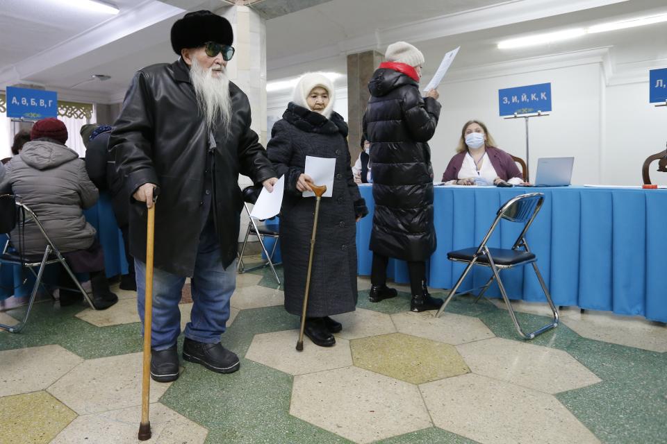 Elderly voters hold their ballots at a polling station in Astana, Kazakhstan, Sunday, Nov. 20, 2022. Kazakhstan's president appears certain to win a new term against little-known challengers in a snap election on Sunday. Five candidates are on the ballot against President Kassym-Jomart Tokayev, who faced a bloody outburst of unrest early this year and then moved to marginalize some of the Central Asian country's longtime powerful figures. (AP Photo/Stanislav Filippov)