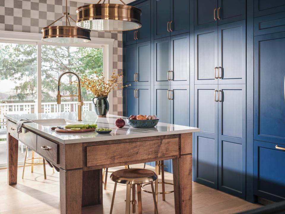 Built by Louisville’s Twin Spires Remodeling and decked out by HGTV interior designer Brian Patrick Flynn, the house is part of the HGTV Urban Oasis 2023 sweepstakes. Pictured here is the kitchen island and blue built-in cabinets.