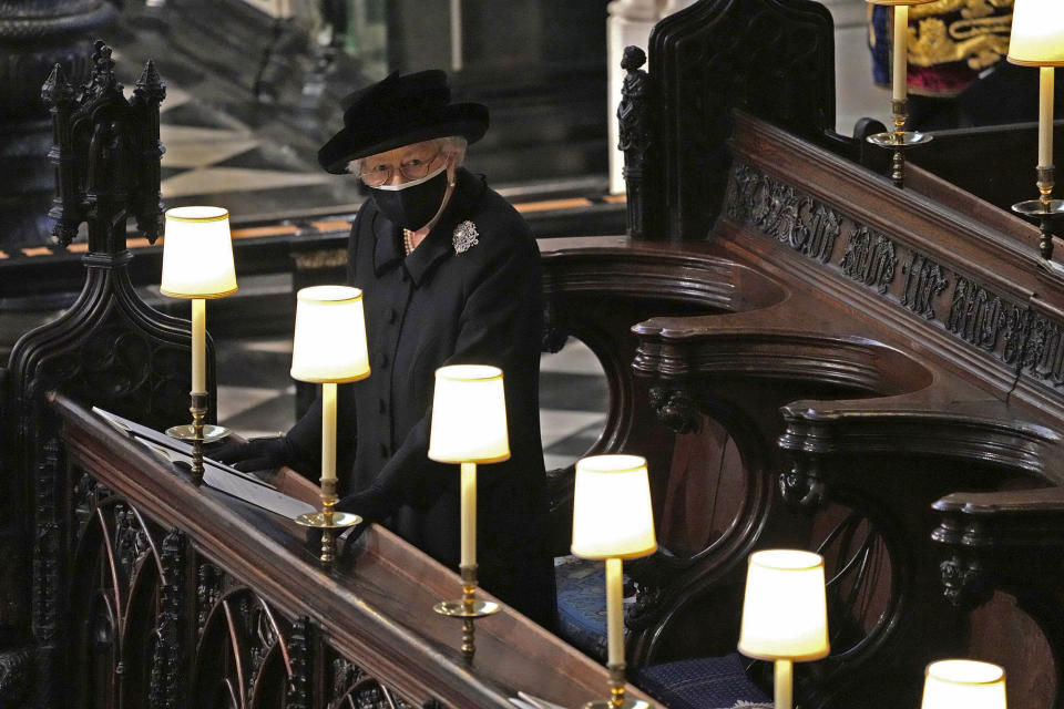 Image: Britain's Queen Elizabeth II takes her seat alone in St. George's Chapel during the funeral of Prince Philip. (Yui Mok / Pool via AP)