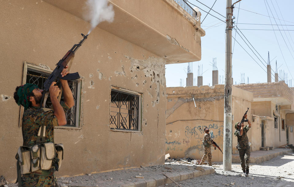 <p>Kurdish fighters from the People’s Protection Units (YPG) fire rifles at a drone operated by Islamic State militants in Raqqa, Syria, June 16, 2017. (Photo: Goran Tomasevic/Reuters) </p>