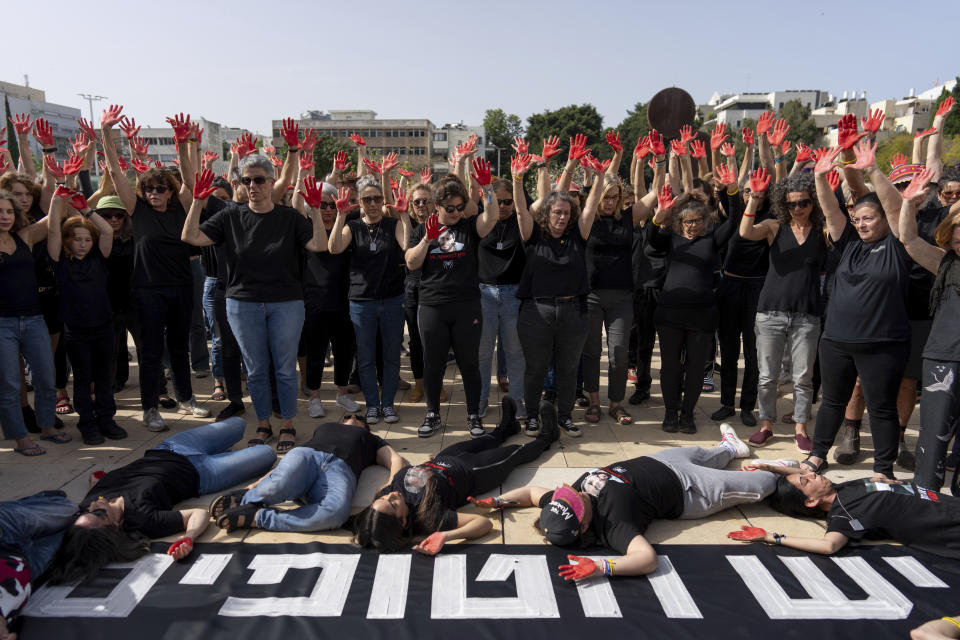 Family and supporters of hostages held in the Gaza Strip hold up their hands, painted red to symbolize blood, to call for the captives' release and to mark 200 days since the Hamas-led Oct. 7 cross-border attack, in Tel Aviv, Israel, Tuesday, April 23, 2024. (AP Photo/Ohad Zwigenberg)