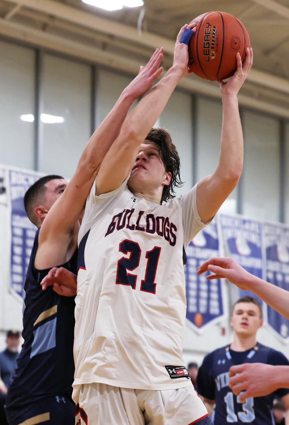 Rockland's Michael Moriarty scores a basket on East Bridgewater defender Ethan Pohl during a game on Tuesday, Jan. 17, 2023.