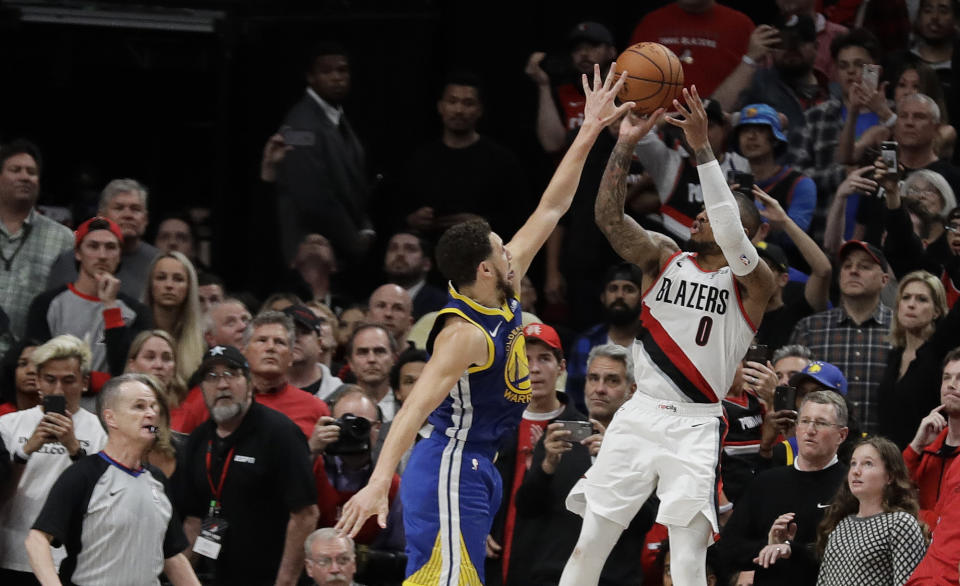 Portland Trail Blazers guard Damian Lillard, right, shoots under pressure from Golden State Warriors guard Klay Thompson, left, in the final seconds of overtime in of Game 4 of the NBA basketball playoffs Western Conference finals against the Golden State Warriors, Monday, May 20, 2019, in Portland, Ore. The shot fell short and the Warriors won 119-117 in overtime. (AP Photo/Ted S. Warren)