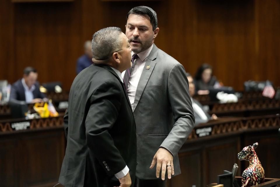 Arizona State Rep. Leo Biasiucci, R, speaks with Rep. Lupe Contreras, D, left, at the Capitol, Tuesday, June 4, 2024, in Phoenix. The Arizona legislature gave final approval to a the proposal that will ask voters to make it a state crime for noncitizens to enter the state through Mexico at any location other than a port of entry. (AP Photo/Matt York)