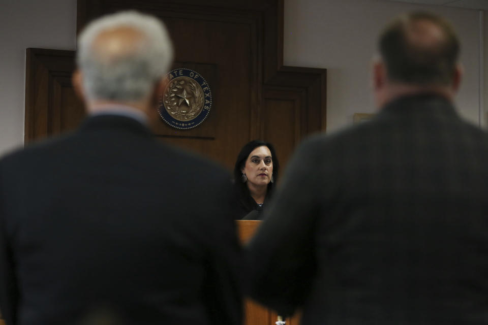 Judge Maya Guerra Gamble speaks to Alex Jones during his trial at the Travis County Courthouse in Austin, Texas, Tuesday, July 26, 2022. An attorney for the parents of one of the children who were killed in the Sandy Hook Elementary School shooting told jurors that Jones repeatedly “lied and attacked the parents of murdered children” when he told his Infowars audience that the 2012 attack was a hoax. Attorney Mark Bankston said during his opening statement to determine damages against Jones that Jones created a “massive campaign of lies” and recruited “wild extremists from the fringes of the internet ... who were as cruel as Mr. Jones wanted them to be" to the victims' families. Jones later blasted the case, calling it a “show trial” and an assault on the First Amendment. (Briana Sanchez/Austin American-Statesman via AP, Pool)