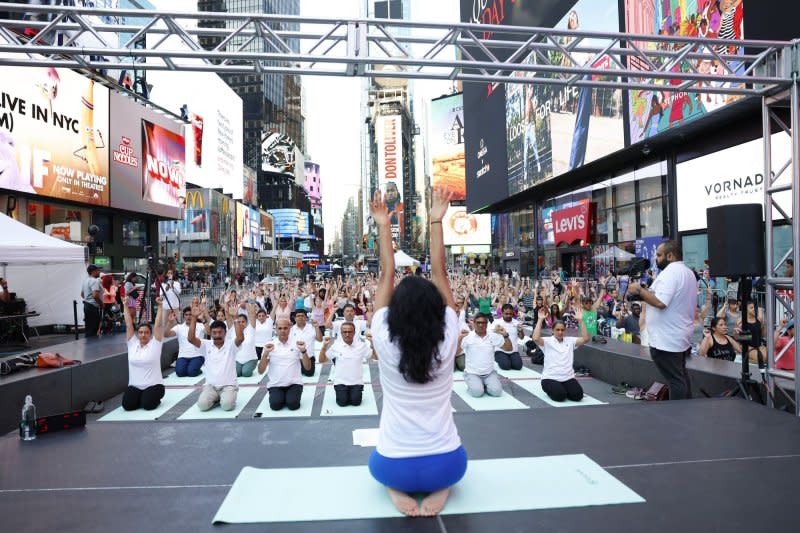 People attend a yoga class in celebration of the summer solstice at the 22nd annual all-day outdoor yoga event in Times Square in New York on Thursday. Photo by John Angelillo/UPI