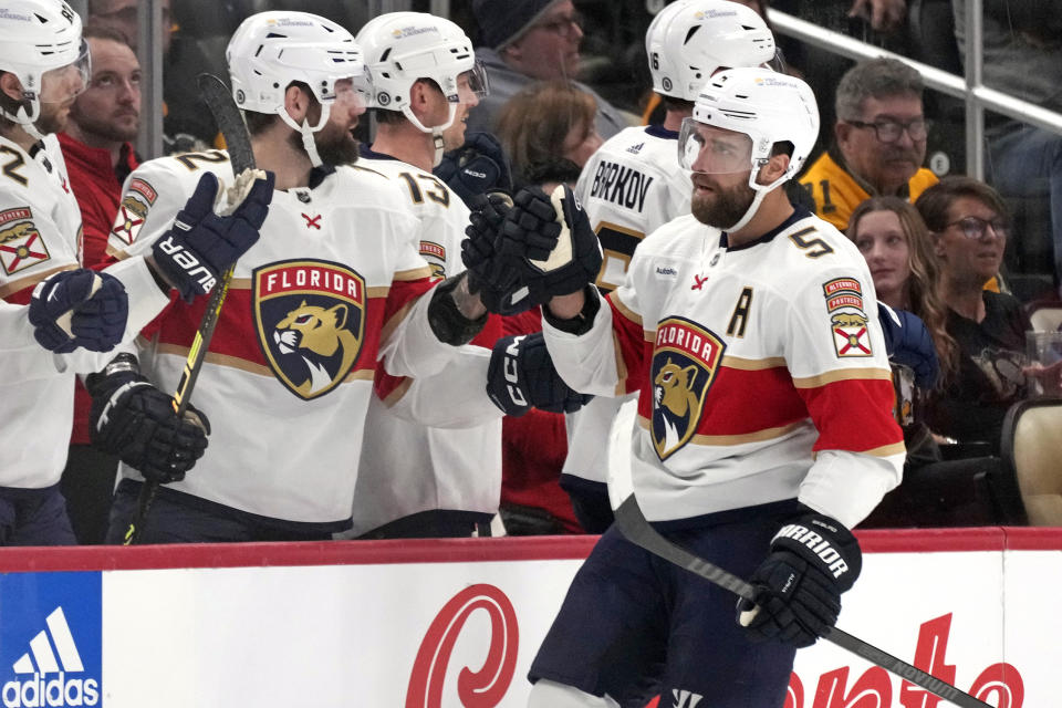 Florida Panthers' Aaron Ekblad (5) returns to the bench after scoring during the second period of an NHL hockey game against the Pittsburgh Penguins in Pittsburgh, Wednesday, Feb. 14, 2024. (AP Photo/Gene J. Puskar)