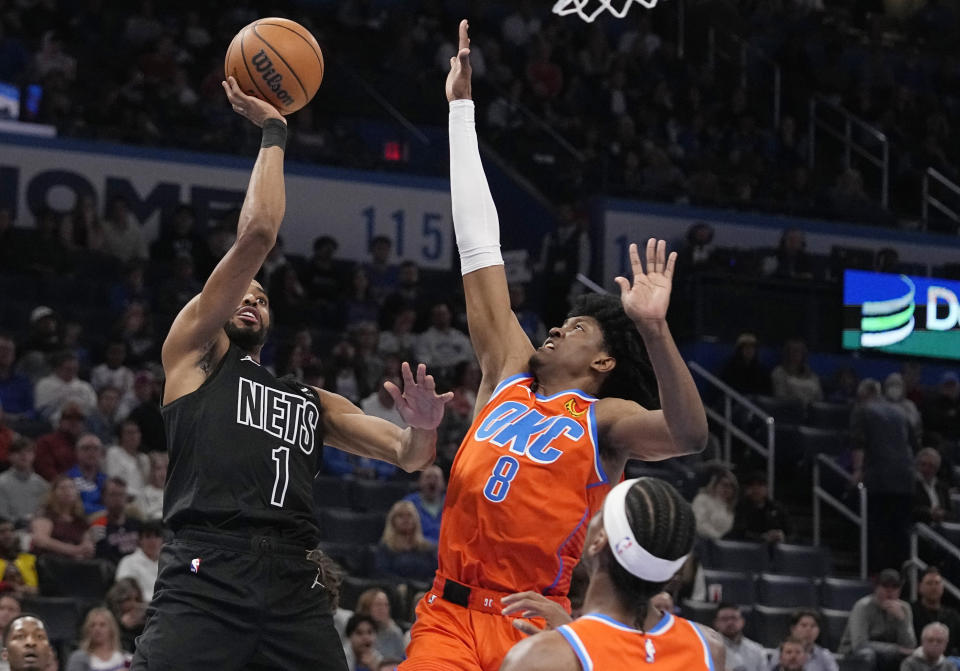 Brooklyn Nets forward Mikal Bridges (1) shoots next to Oklahoma City Thunder forward Jalen Williams (8) during the first half of an NBA basketball game Tuesday, March 14, 2023, in Oklahoma City. (AP Photo/Sue Ogrocki)