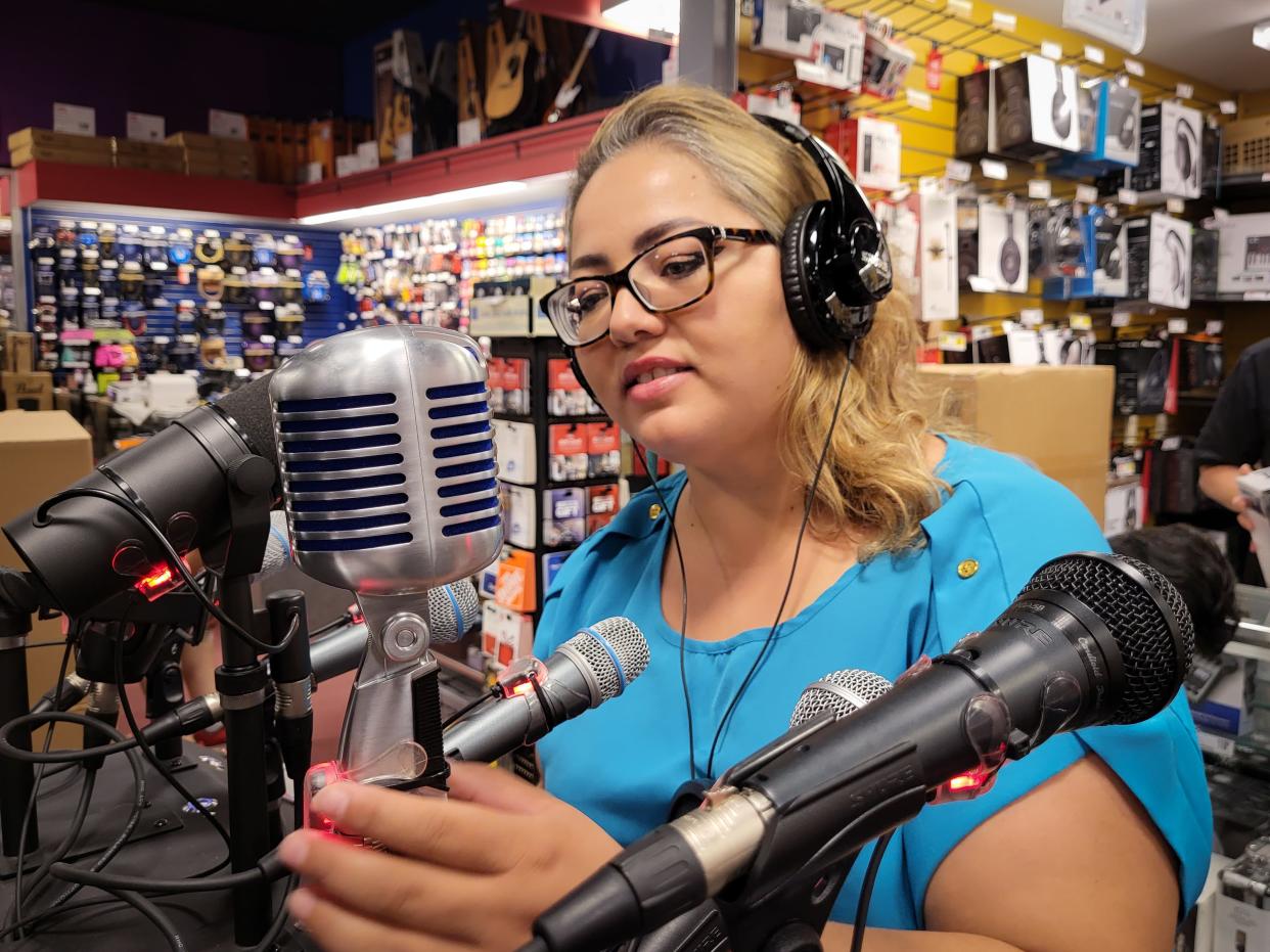 Selene Zamorano-Ochoa, president of the South Dakota Hispanic Chamber of Commerce, looks at microphones on Tuesday, September 6, at Guitar Center in Sioux Falls. The mic would be used for the Chamber's new Spanish radio station.