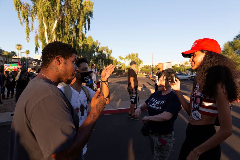 FILE PHOTO: Black Lives Matter protesters interact with protesters against restrictions to prevent the spread of the coronavirus disease (COVID-19) in Phoenix