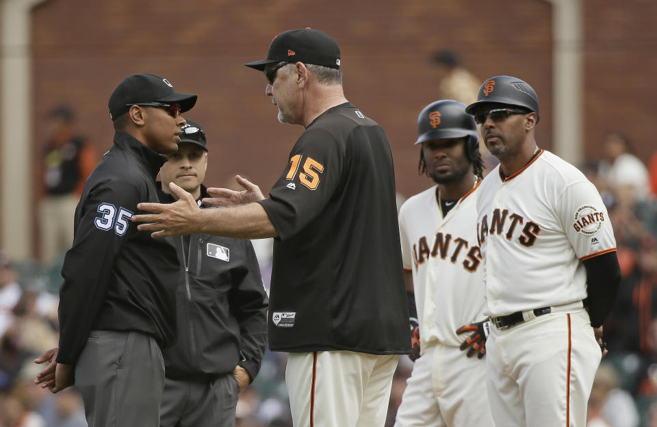 San Francisco Giants manager Bruce Bochy argues with first base umpire Jeremie Rehab after Alen Hanson, second from right, was called out at first base on a sacrifice in the seventh inning of a baseball game against the Atlanta Braves Wednesday, Sept. 12, 2018, in San Francisco. At right is Giants first base coach Jose Alguacil. (AP Photo/Eric Risberg)