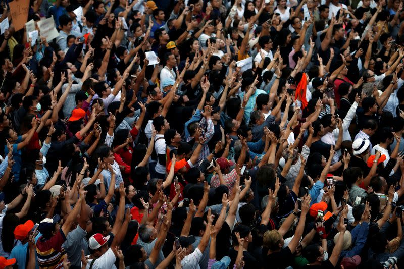 Supporters wave their hands during an unauthorised flash mob rally by the progressive Future Forward Party in Bangkok