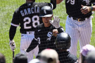 Chicago White Sox's Jake Lamb, center, celebrates after he hit a two-run home run during the third inning of the first baseball game of a doubleheader against the Baltimore Orioles, Saturday, May 29, 2021, in Chicago. (AP Photo/Matt Marton)