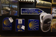 Souvenirs of St. James Way are displayed for sale at a shop in Roncesvalles, where the French route of Spain Saint James Way starts, Northern Spain, Saturday, April 10, 2021. The pilgrims are trickling back to Spain's St. James Way after a year of being kept off the trail due to the pandemic. Many have committed to putting their lives on hold for days or weeks to walk to the medieval cathedral in Santiago de Compostela in hopes of healing wounds caused by the coronavirus. (AP Photo/Alvaro Barrientos)