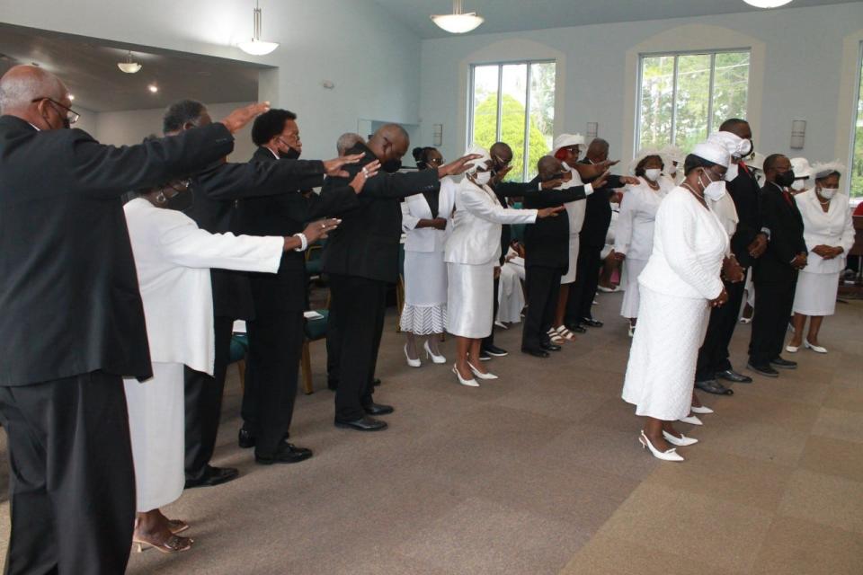 Pastors and religious leaders pray over church members of DaySpring Baptist Church who were elevated and consecrated during a convocation service held Sunday at the church.