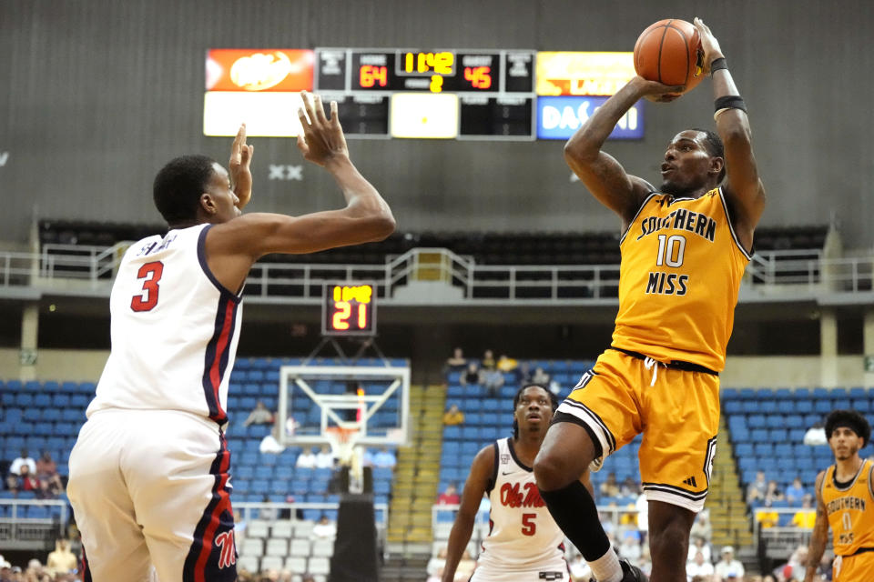 Southern Mississippi guard Cobie Montgomery (10) attempts to shoot past Mississippi forward Jamarion Sharp (3) during the second half of an NCAA college basketball game, Saturday, Dec. 23, 2023, in Biloxi, Miss. (AP Photo/Rogelio V. Solis)