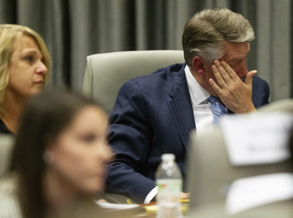 Mark Harris, Republican candidate in North Carolina's 9th Congressional race, fights back tears at the conclusion of his son John Harris's testimony during the third day of a public evidentiary hearing on the 9th Congressional District voting irregularities investigation Wednesday, Feb. 20, 2019, at the North Carolina State Bar in Raleigh. (Travis Long/The News & Observer via AP, Pool)