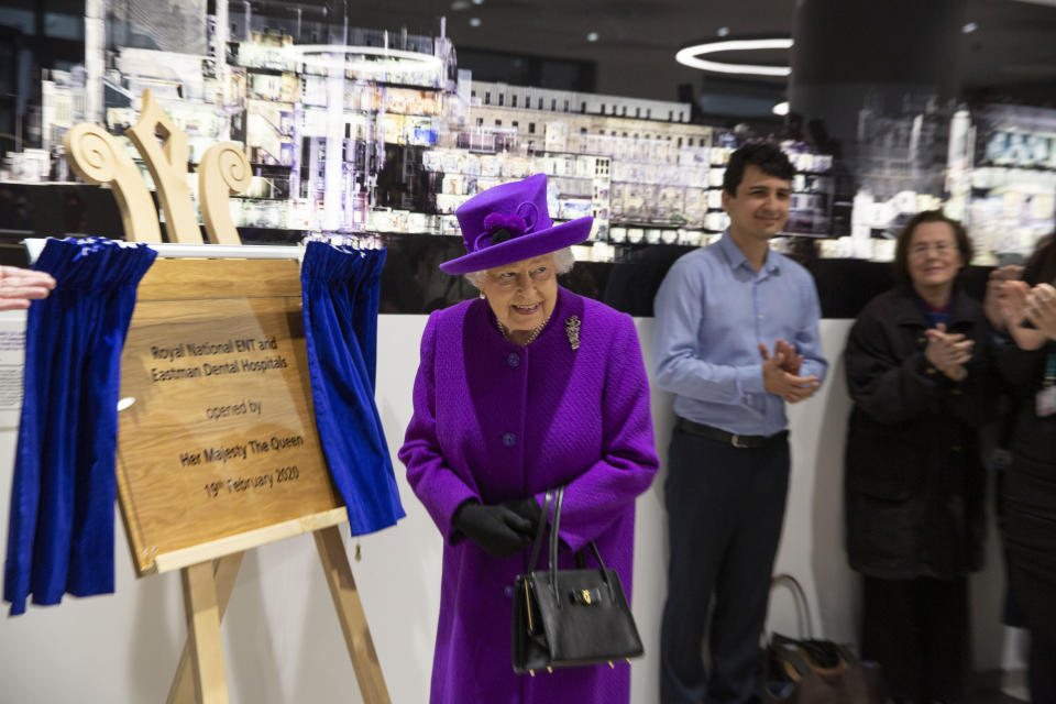 Queen Elizabeth II unveils a plaque during the official opening of the new premises of the Royal National ENT and Eastman Dental Hospitals in London.