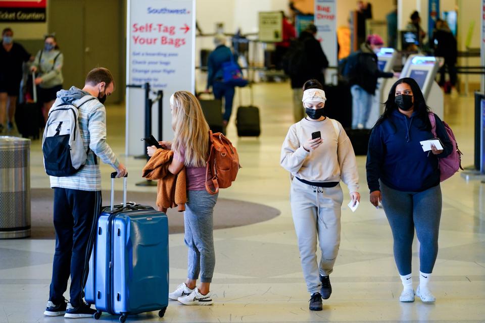 Travelers wearing protective masks as a precaution against the spread of the coronavirus move about a  terminal at the Philadelphia International Airport in Philadelphia last month, A federal judge in Florida struck down the federal mask mandate for airplane travel. (AP Photo/Matt Rourke)