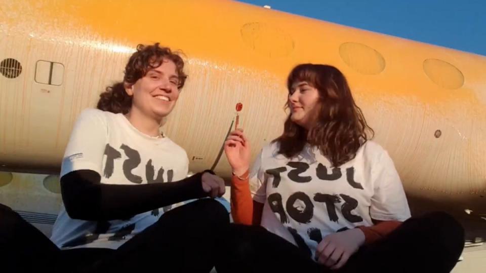 Just Stop Oil protesters after they sprayed orange paint over parked private jets at London Stansted (Just Stop Oil/PA Wire)