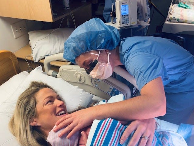 Allie LaForce holds her newborn son, Jacob Michael Smith, while her sister, Dr. AuBree LaForce, checks on him at Cleveland Clinic Akron General.