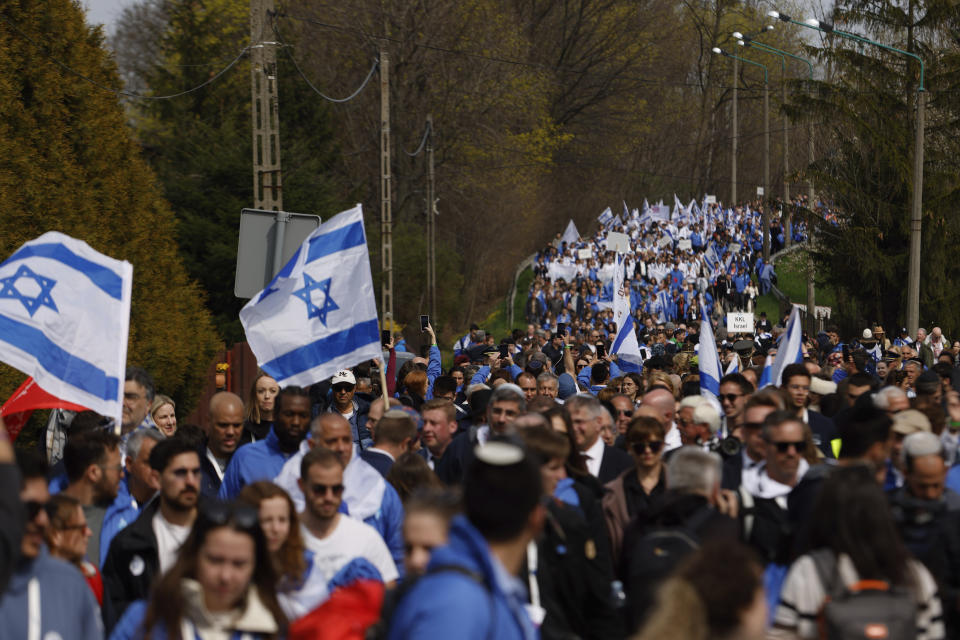 People participate in the annual 'March of the Living', a trek between two former Nazi-run death camps, in Oswiecim, Poland, Tuesday, April 18, 2023 to mourn victims of the Holocaust and celebrate the existence of the Jewish state. (AP Photo/Michal Dyjuk)