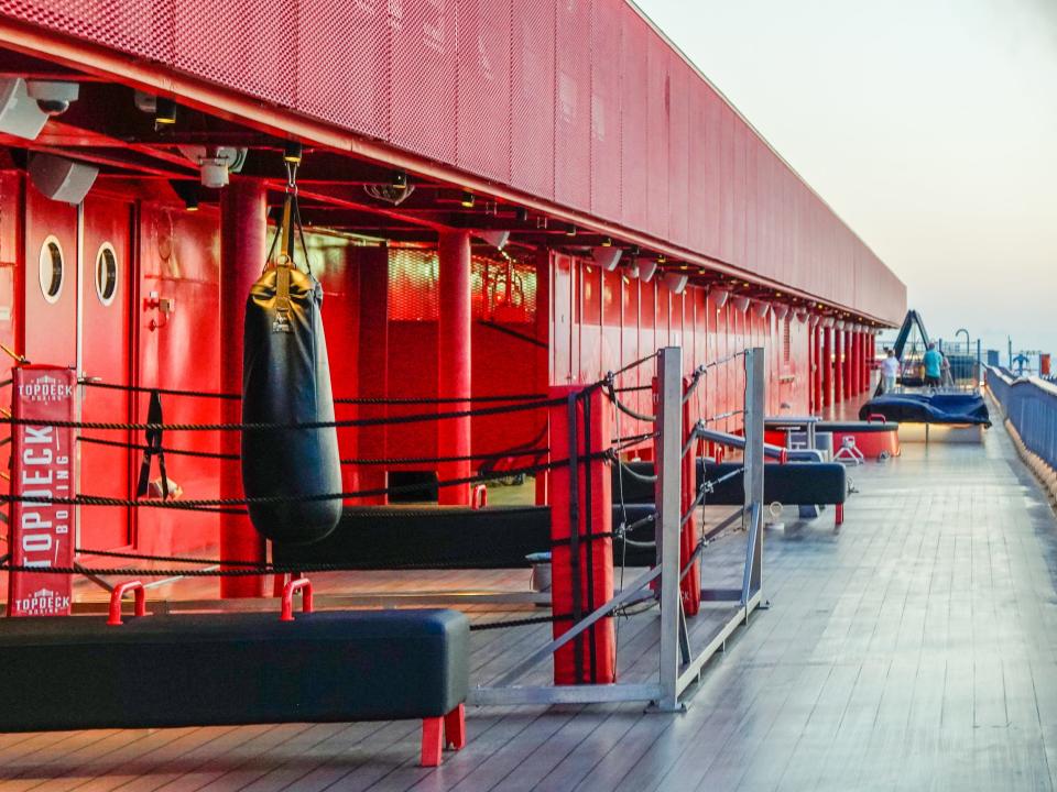 Black and red workout equipment on the left side of an outdoor cruise ship deck