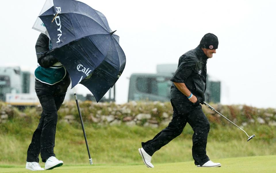 Not sure how effective the umbrella was on the Welsh coast as Alex Cejka&#39;s caddie illustrates