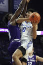 Kentucky's Jacob Toppin (0) shoots while defended by High Point's Emmanuel Izunabor, left, during the first half of an NCAA college basketball game in Lexington, Ky., Friday, Dec. 31, 2021. (AP Photo/James Crisp)