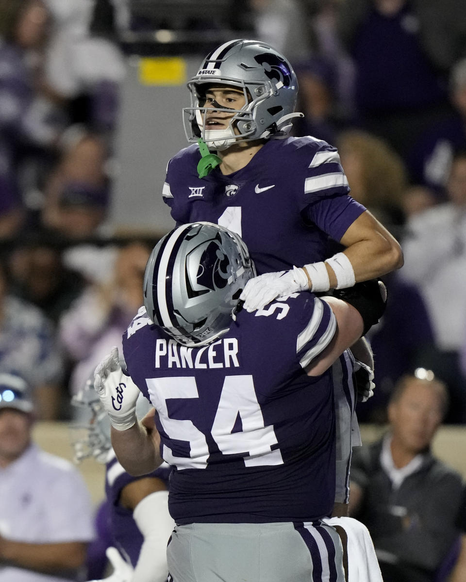 Kansas State wide receiver Jayce Brown (1) is hoisted by offensive lineman Hadley Panzer (54) after scoring a touchdown during the second half of an NCAA college football game against TCU Saturday, Oct. 21, 2023, in Manhattan, Kan. (AP Photo/Charlie Riedel)