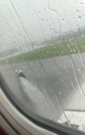 Emergency officials spray water towards the plane in Pontianak, Kalimantan, Indonesia February 16, 2019 in this still image taken from a video obtained from social media. ANGELA MERICI PAULIN FELITA/via REUTERS