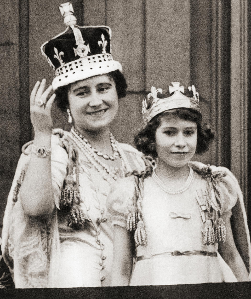 Queen Elizabeth on the day of her coronation in 1936 with her daughter Princess Elizabeth on the balcony of Buckingham Palace, London, England. Elizabeth Angela Marguerite Bowes-Lyon, 1900 –2002. Princess Elizabeth, future Queen Elizabeth II. Elizabeth II, born 1926. Queen of the United Kingdom, Canada, Australia and New Zealand. (Photo by: Universal History Archive/Universal Images Group via Getty Images)