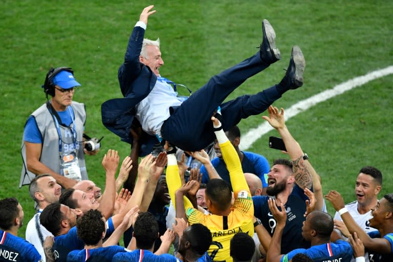 France coach Didier Deschamps is thrown into the air by his players after their World Cup win