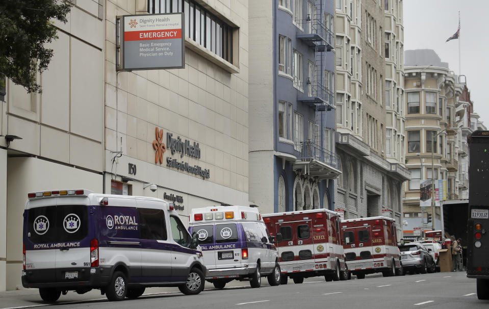 FILE - In this March 18, 2020 file photo Ambulances park in front of Saint Francis Memorial Hospital in San Francisco. After months spent tamping down surges and keeping the coronavirus at manageable levels, a variety of factors combined to bring California to a crisis point in the pandemic. (AP Photo/Ben Margot,File)