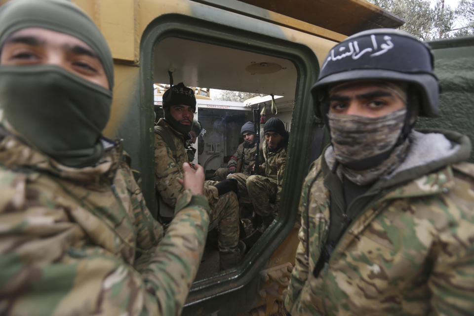 Turkish backed Syrian fighters prepare to go to frontline in Idlib province, Syria. Tuesday, Feb. 11, 2020. The fighting on Tuesday concentrated near the village of Nairab as rebels, with the backing of Turkish artillery, tried to retake the village that they lost last week, according to opposition activists. (AP Photo/Ghaith Alsayed)