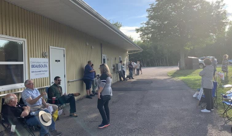 Residents gathered outside the municipal office of Beausoleil to protest a new rule requiring business signs be bilingual.