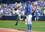 Aug 15, 2015; Toronto, Ontario, CAN; Toronto Blue Jays starting pitcher Marco Estrada (25) watches New York Yankees right fielder Carlos Beltran (36) round the bases after hitting a home run in the first inning at Rogers Centre. Dan Hamilton-USA TODAY Sports