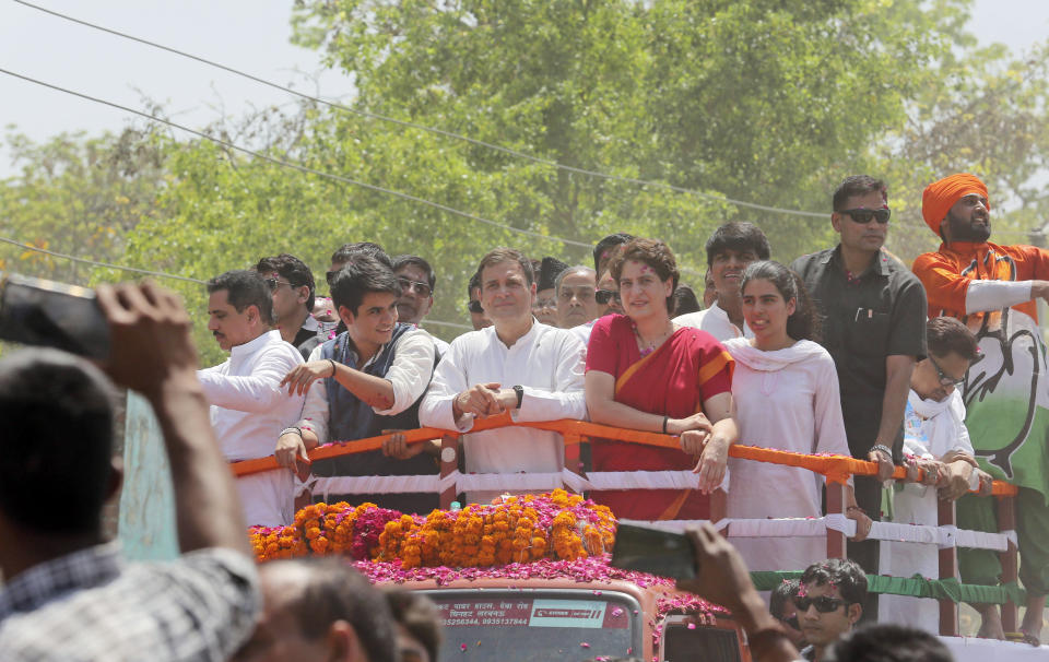 Congress party chief Rahul Gandhi, center in white, accompanied by his sister Priyanka Vadra in red arrives to file his nomination papers for the upcoming general elections in Amethi, Uttar Pradesh state, India, Wednesday, April 10, 2019. Gandhi, the scion of India’s most famous political dynasty, filed nomination papers in the family stronghold of Amethi hoping to hold onto a key seat for a fourth consecutive time in national elections that begin Thursday. (AP Photo/Rajesh Kumar Singh)