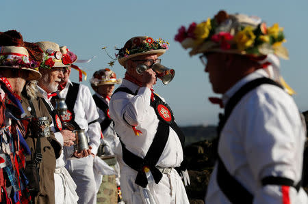 Leicester Morrismen drink beer during May Day celebrations at Bradgate Park in Newtown Linford, Britain May 1, 2018. REUTERS/Darren Staples